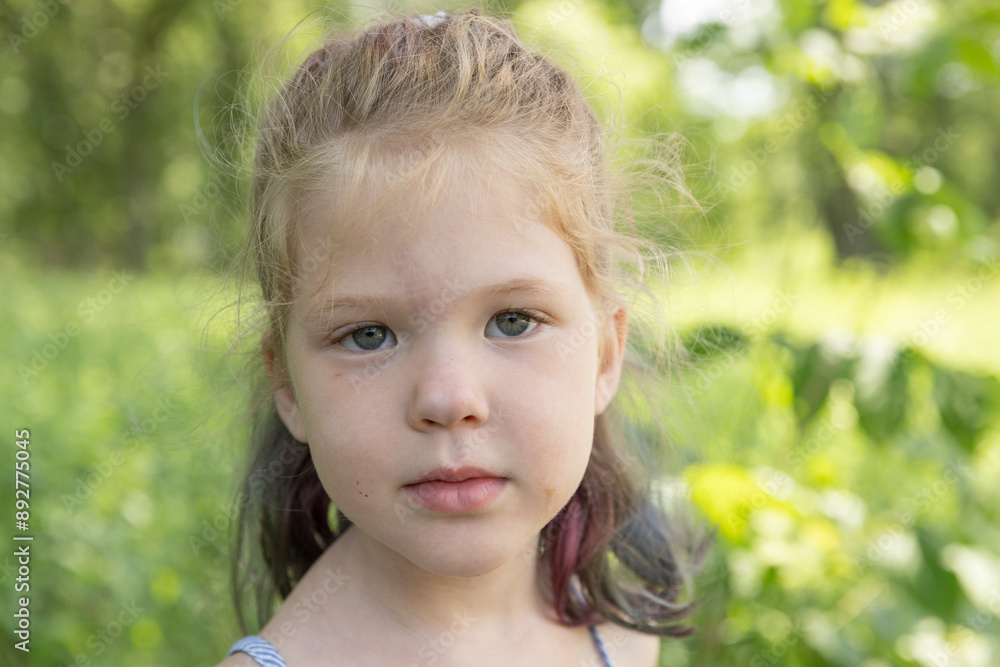 Contemplating girl looks at the camera for a portrait Contemplating girl looks at the camera for a portrait