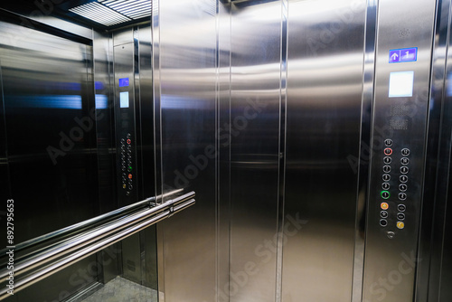 Gray metal elevator with a mirror in front of the door