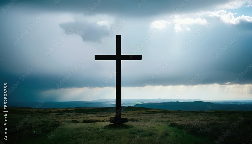 A silhouette of a cross stands on a scenic hilltop under a dramatic sky.Religious Wallpaper Background. A silhouette of a cross stands on a scenic hilltop under a dramatic sky.Religious Wallpaper Background.