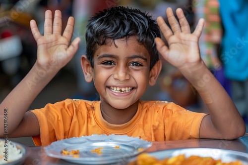 Young boy happy expression curly hair and raised hands pink. Playful curly-haired child smiling happily hands up excitement. Friendly nature of youth shown enthusiastic smiling face. photo