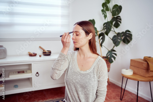 beautiful caucasian woman using acupressure tool in her forehead, facial yoga and anti aging 