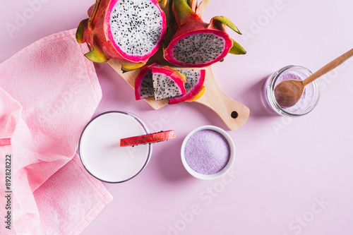 Trendy pink matcha dragon fruit latte in a glass on the table top view photo