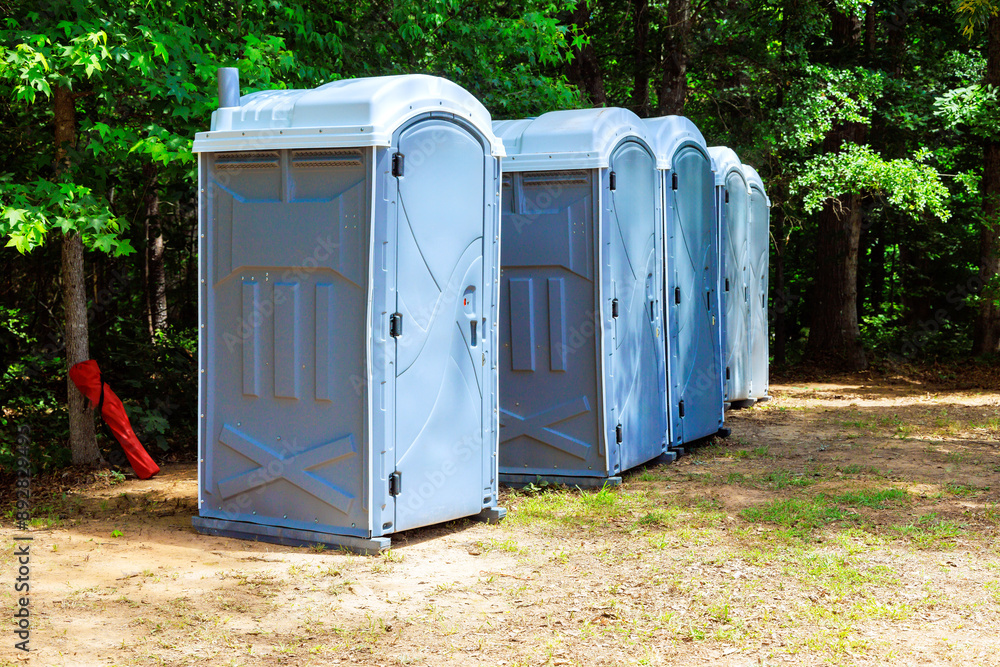 In park center at city, there are row of portable biochemical toilets In park center at city, there are row of portable biochemical toilets