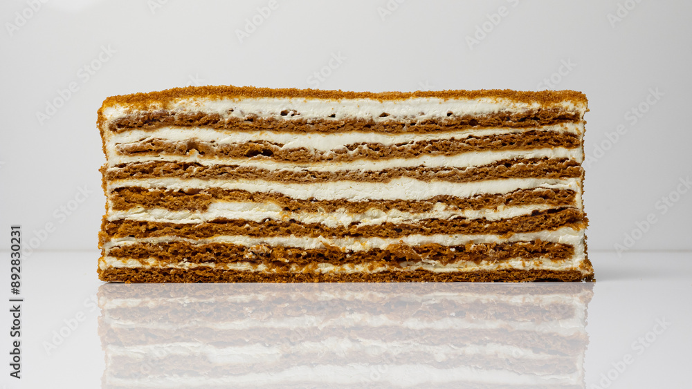 Fototapeta premium Section of a cake on a white background, cake layers, cream, pastries, dessert.