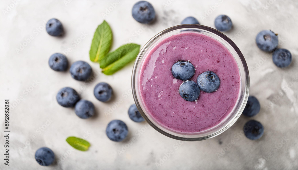 Blueberry smoothie, fresh berries on stone table. Delicious summer drink. Tasty beverage. Flat lay Blueberry smoothie, fresh berries on stone table. Delicious summer drink. Tasty beverage. Flat lay