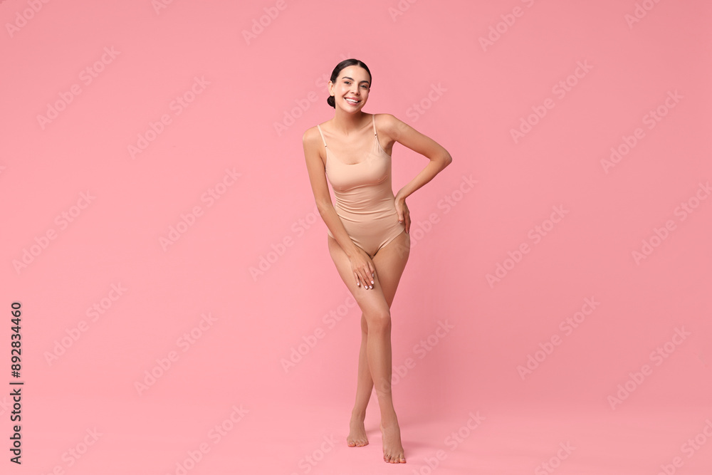 Fototapeta premium Smiling woman with perfect skin on pink background. Body care