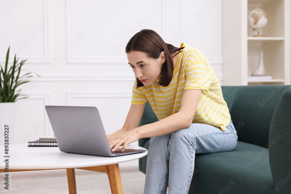 Woman with poor posture using laptop at home Woman with poor posture using laptop at home