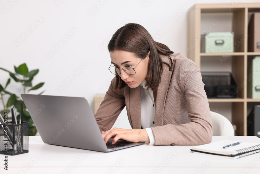 Woman with poor posture working in office Woman with poor posture working in office
