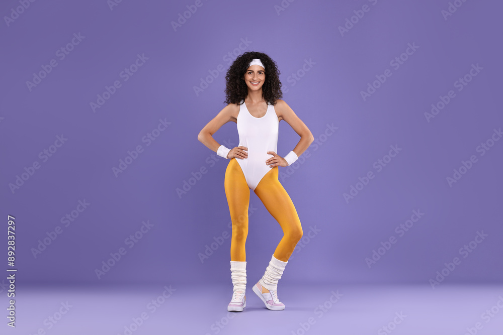 Happy woman in sportswear on purple background Happy woman in sportswear on purple background