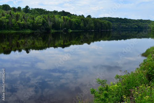Mississisagi River, Ontario with reflections of sky and forest