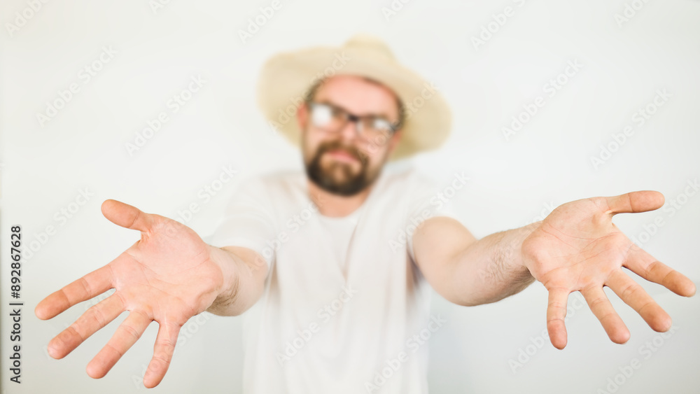 portrait of handsome bearded man with straw hat and glasses smiling, hand gesture no, wearing white shirt , isolated on white background