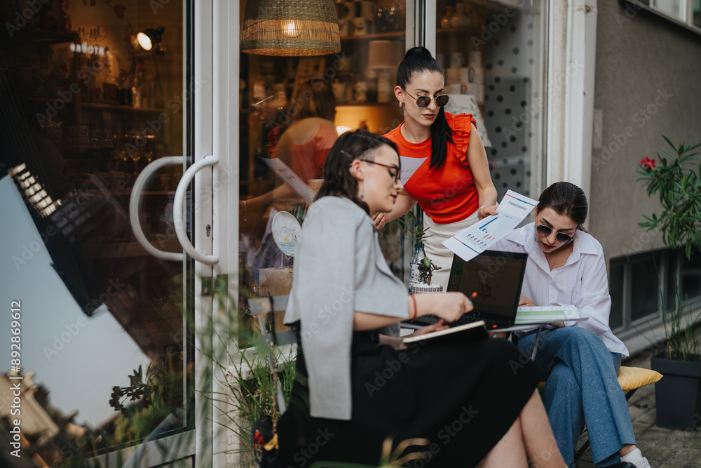Three businesswomen gather outside a cafe, engaging in a meeting with documents and laptops. They are focused on collaboration and productivity. Three businesswomen gather outside a cafe, engaging in a meeting with documents and laptops. They are focused on collaboration and productivity.
