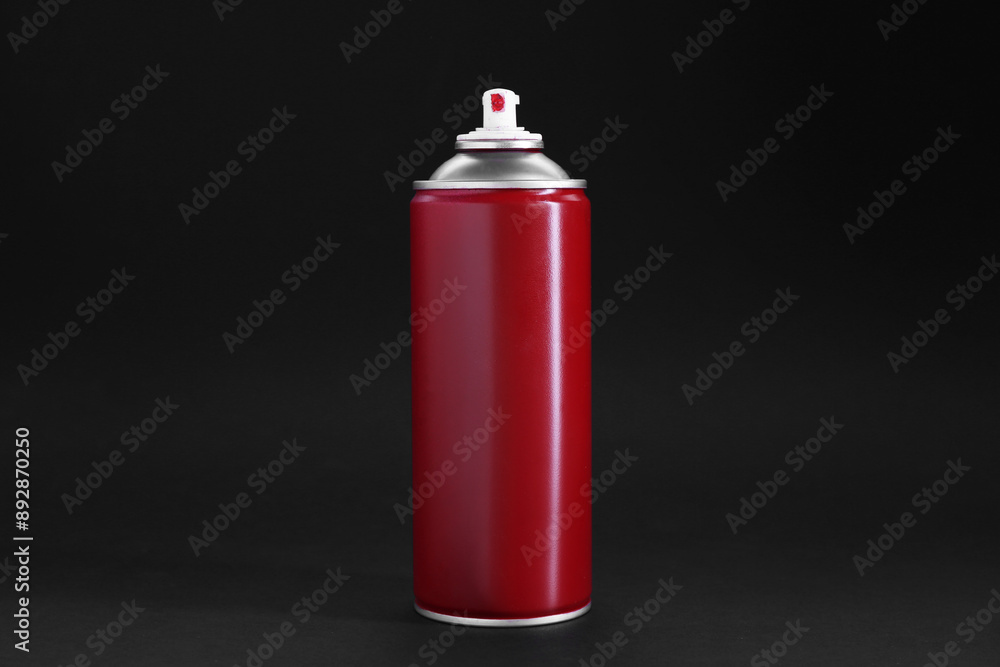 Red spray paint can on dark gray background Red spray paint can on dark gray background