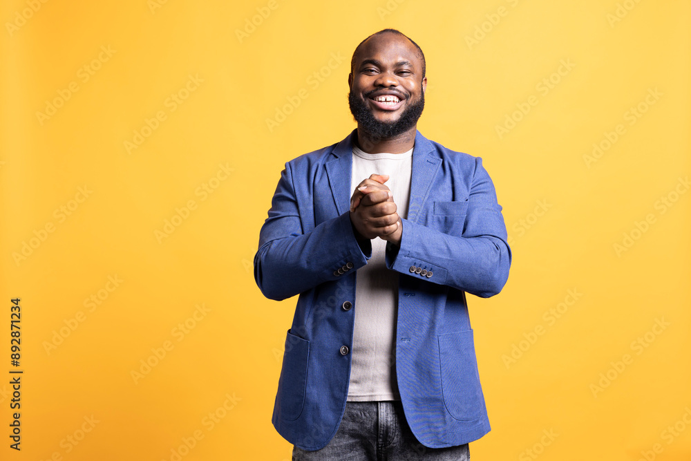 Portrait of happy african american man posing with hands put together, looking pleased, isolated over studio background. Lively radiant BIPOC person smiling, feeling satisfied Portrait of happy african american man posing with hands put together, looking pleased, isolated over studio background. Lively radiant BIPOC person smiling, feeling satisfied