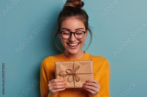 Woman Holding Gift, Smiling, Blue Background