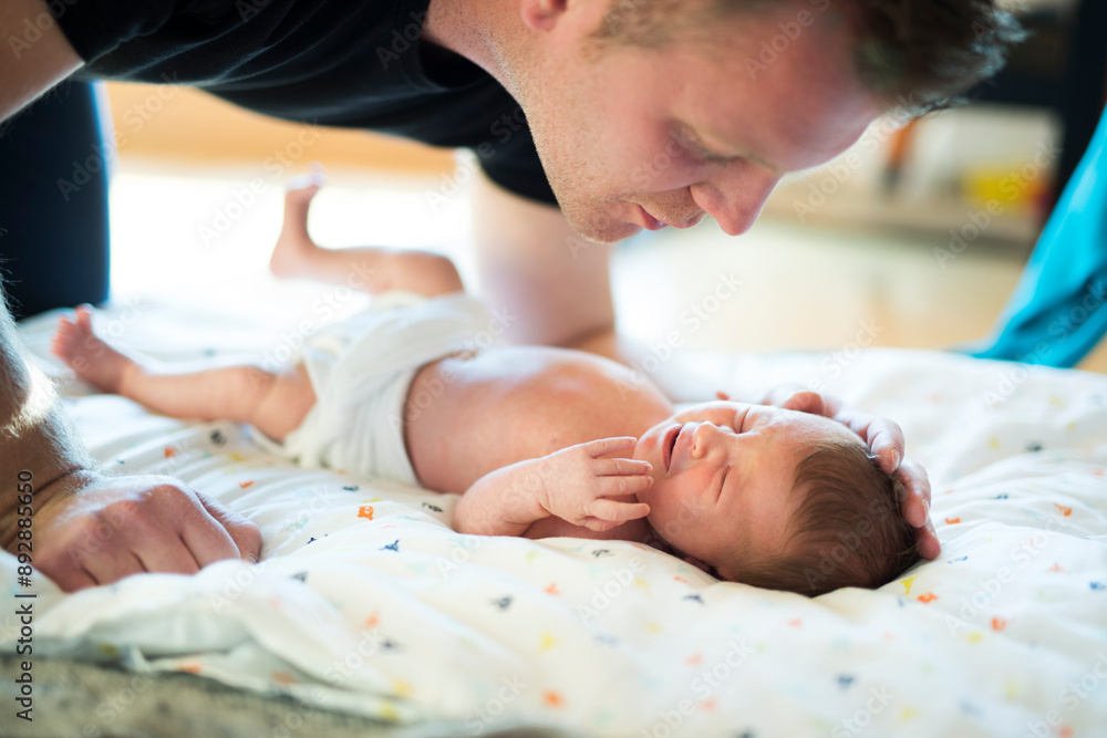Father looking at his newborn baby. Unconditional paternal love, Father's Day concept. Father looking at his newborn baby. Unconditional paternal love, Father's Day concept.