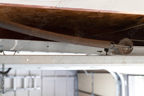 Garage door extension spring. Automatic garage door spring with safety cable