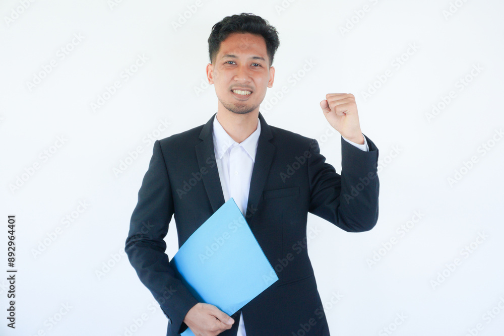 Asian businessman clenched fist showing optimist expression Asian businessman clenched fist showing optimist expression