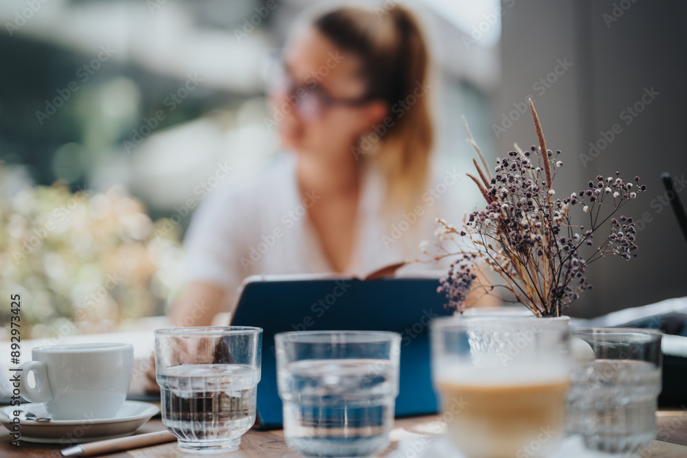 Startup team in a business meeting, discussing strategy and brainstorming ideas over coffee at a modern cafe setting. Startup team in a business meeting, discussing strategy and brainstorming ideas over coffee at a modern cafe setting.