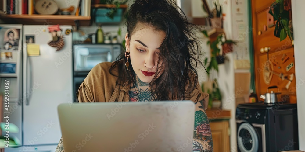 Young Generation Z entrepreneur working on laptop in home office - tattooed professional Young Generation Z entrepreneur working on laptop in home office - tattooed professional