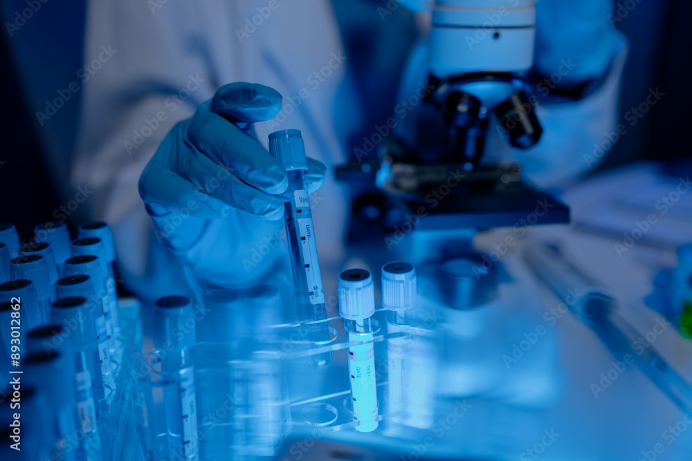scientist is working on an important liquid inside tube in laboratory, the discovery of a vaccine to protect against currently spreading virus has been discovered, wear gloves and goggles for safety scientist is working on an important liquid inside tube in laboratory, the discovery of a vaccine to protect against currently spreading virus has been discovered, wear gloves and goggles for safety