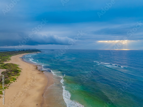 Sunrise Seascape with beautiful cloud covered sky and gentle surf