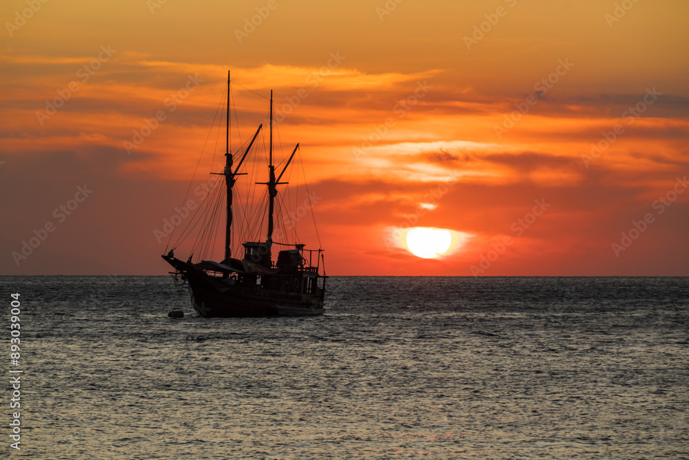 Cruise ship on the sea with sunset over the horizon line Cruise ship on the sea with sunset over the horizon line