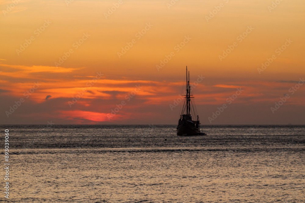 Cruise ship on the sea with sunset over the horizon line Cruise ship on the sea with sunset over the horizon line