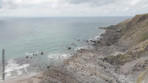 Wallpaper Mural Aerial orbital view of waves gently lapping against the rocky North Atlantic coastline of Cornwall, United Kingdom Torontodigital.ca