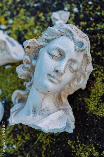 Broken bust of an angel statue smashed on the ashphat. Old Town, Albuquerque, New Mexico, United States Of America.