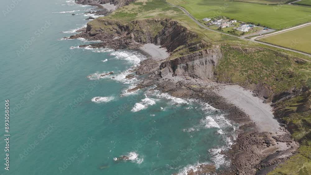 Rising aerial view of coastal erosion along the North Atlantic coast of England, emphasizing the geological changes and natural beauty Rising aerial view of coastal erosion along the North Atlantic coast of England, emphasizing the geological changes and natural beauty
