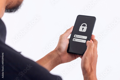 Man holding a smartphone to login username and password on screen. Data privacy online protection on mobile phone application. photo