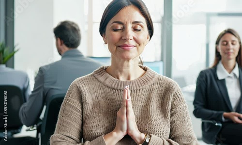 Group portrait video of a woman in her 40s practicing mindfulness sophrology relaxation & stress-reduction wearing a cozy sweater against an office or corporate background