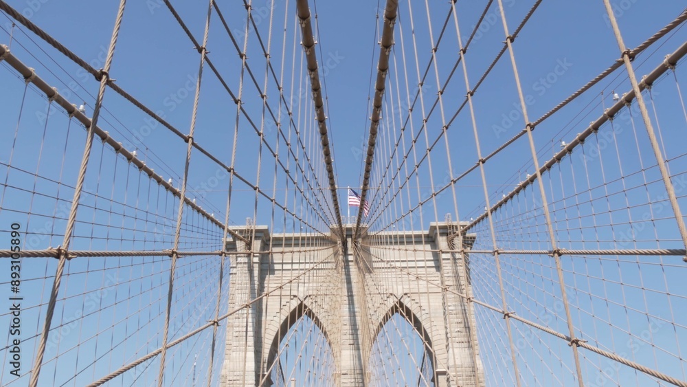 Obraz premium Brooklyn Bridge to Manhattan downtown, cables and blue sky. New York City iconic symbol, USA travel destination. Architecture of United States of America, tourist landmark. Famous cable-stayed bridge.