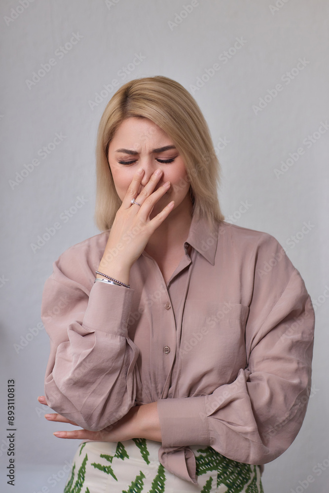 A portrait of an attractive young professional woman with blonde hair, wearing a light brown shirt A portrait of an attractive young professional woman with blonde hair, wearing a light brown shirt