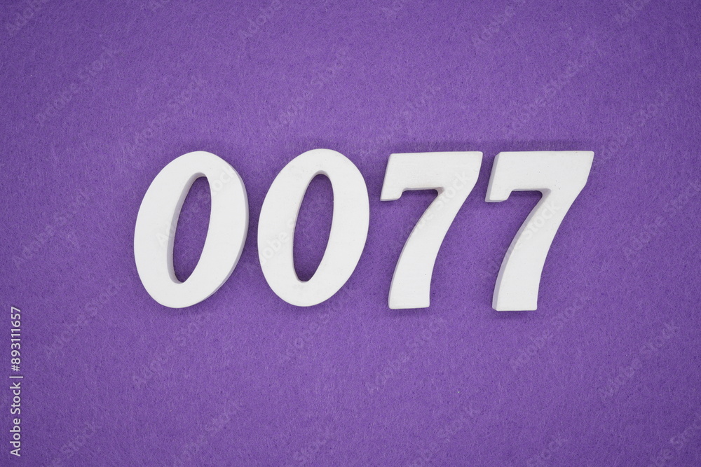 The numbers are made of white paint wood, placed on the background as a purple paper. The numbers are made of white paint wood, placed on the background as a purple paper.