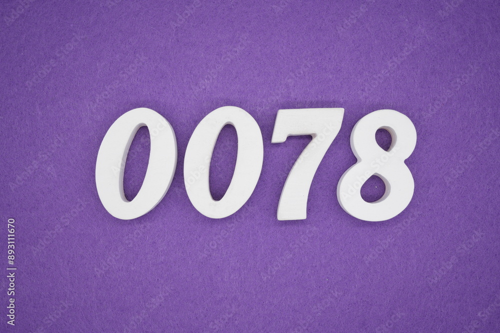 The numbers are made of white paint wood, placed on the background as a purple paper. The numbers are made of white paint wood, placed on the background as a purple paper.