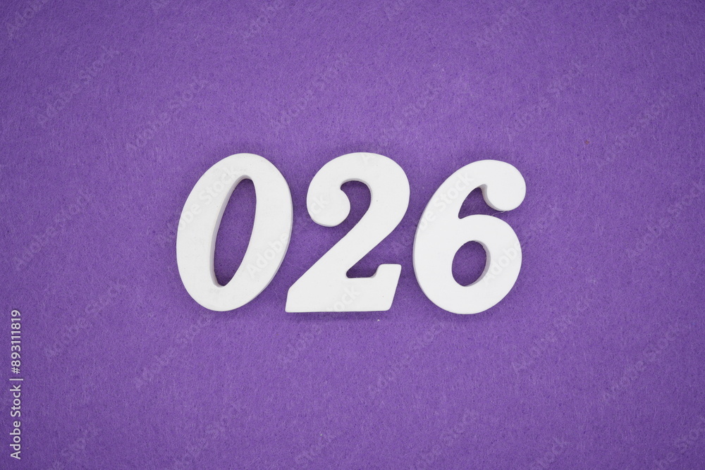 The numbers are made of white paint wood, placed on the background as a purple paper. The numbers are made of white paint wood, placed on the background as a purple paper.