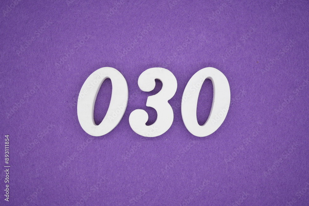 The numbers are made of white paint wood, placed on the background as a purple paper. The numbers are made of white paint wood, placed on the background as a purple paper.