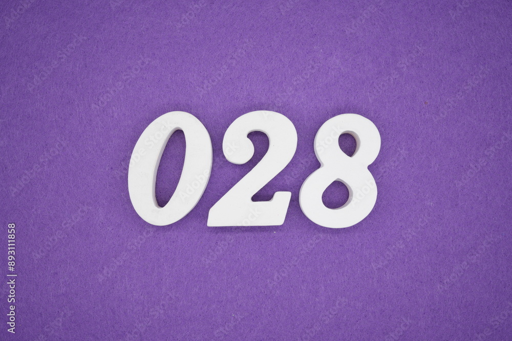 The numbers are made of white paint wood, placed on the background as a purple paper. The numbers are made of white paint wood, placed on the background as a purple paper.