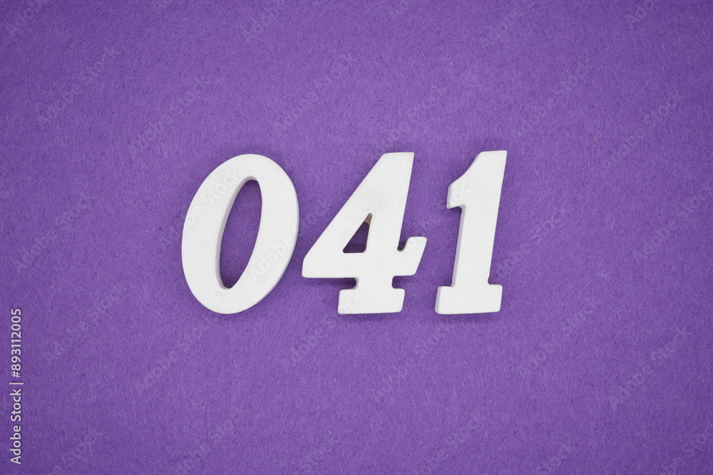 The numbers are made of white paint wood, placed on the background as a purple paper. The numbers are made of white paint wood, placed on the background as a purple paper.