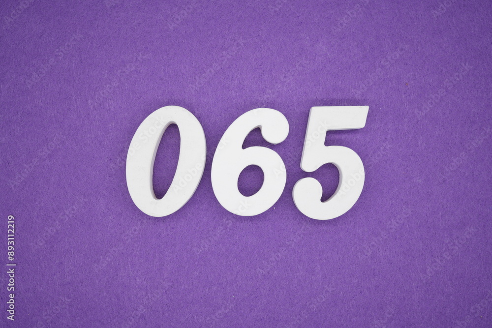 The numbers are made of white paint wood, placed on the background as a purple paper. The numbers are made of white paint wood, placed on the background as a purple paper.