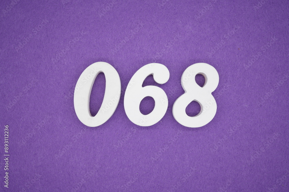 The numbers are made of white paint wood, placed on the background as a purple paper. The numbers are made of white paint wood, placed on the background as a purple paper.