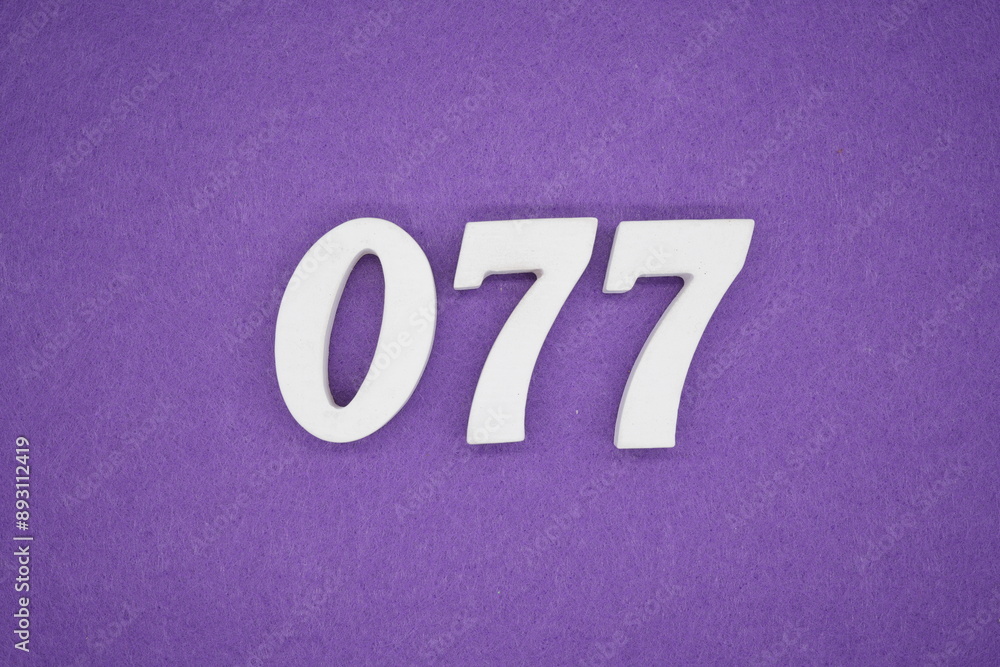 The numbers are made of white paint wood, placed on the background as a purple paper. The numbers are made of white paint wood, placed on the background as a purple paper.