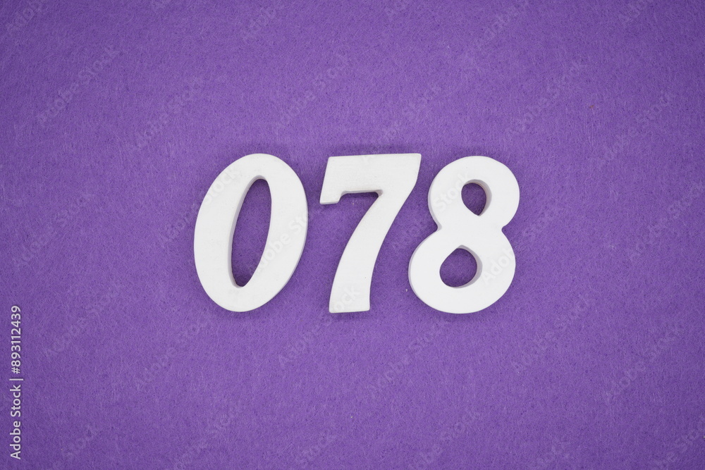 The numbers are made of white paint wood, placed on the background as a purple paper. The numbers are made of white paint wood, placed on the background as a purple paper.