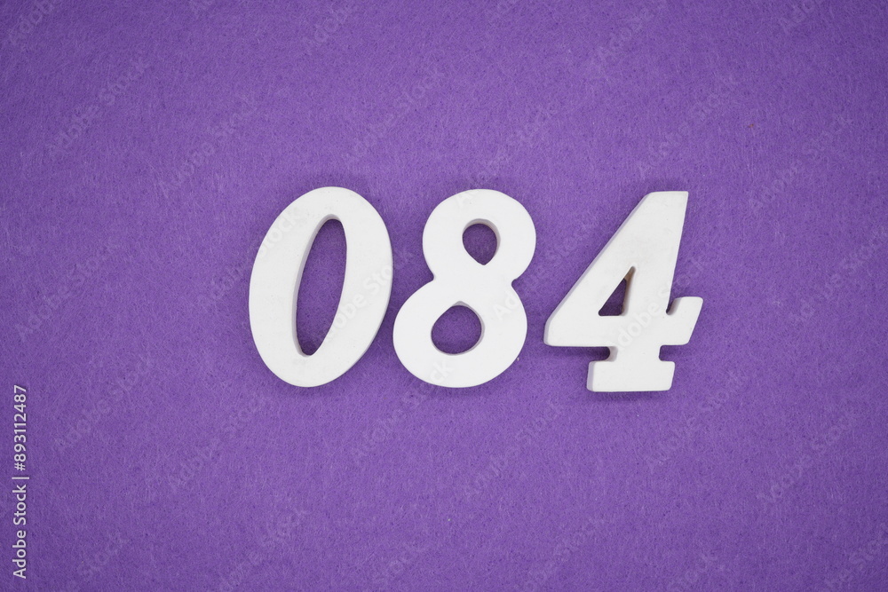 The numbers are made of white paint wood, placed on the background as a purple paper. The numbers are made of white paint wood, placed on the background as a purple paper.