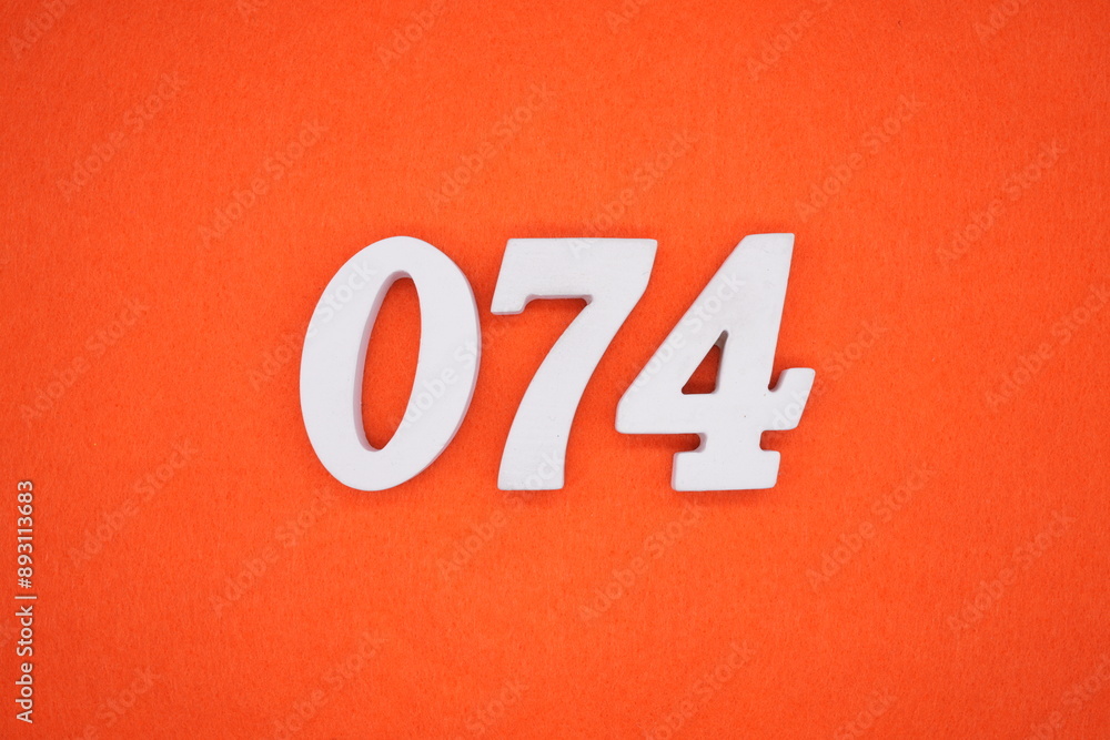 The numbers are made of white painted wood. Placed on the floor was orange paper. The numbers are made of white painted wood. Placed on the floor was orange paper.