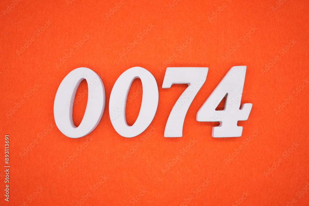 The numbers are made of white painted wood. Placed on the floor was orange paper. The numbers are made of white painted wood. Placed on the floor was orange paper.