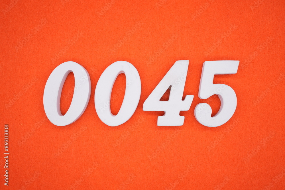 The numbers are made of white painted wood. Placed on the floor was orange paper. The numbers are made of white painted wood. Placed on the floor was orange paper.