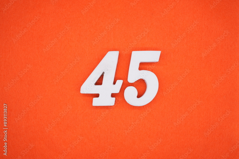 The numbers are made of white painted wood. Placed on the floor was orange paper. The numbers are made of white painted wood. Placed on the floor was orange paper.
